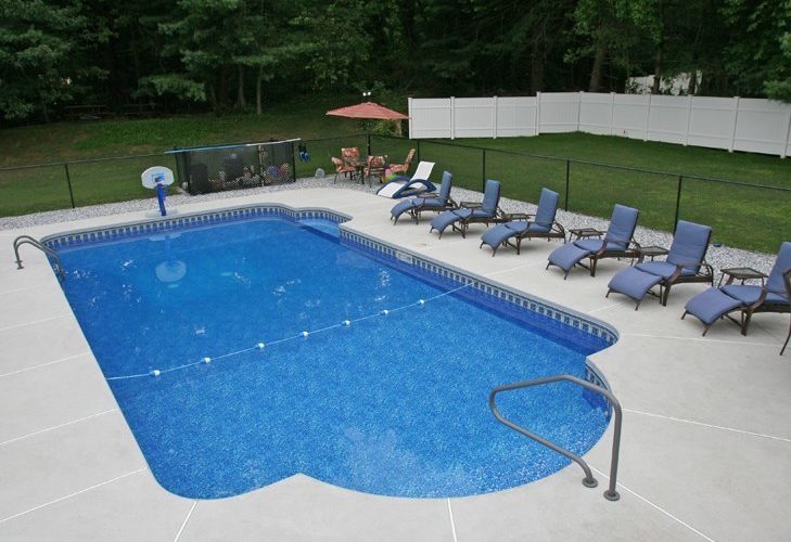 This is a photo of a patrician in ground pool with custom pool house.